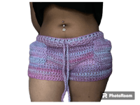 a woman wearing crocheted shorts with a piercing