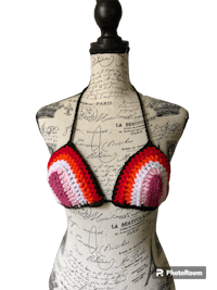 a crocheted bikini top on a mannequin