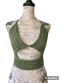 a green crocheted top on a mannequin mannequin