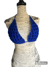 a blue crocheted bikini top on a mannequin